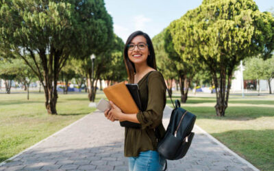 woman on collage campus holding books