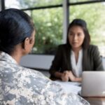 Female Veteran speaking to a lender at a desk