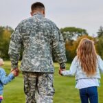 Veteran walking in a field with his family
