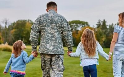 Veteran walking in a field with his family
