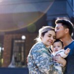 female Veterans with family in front of home