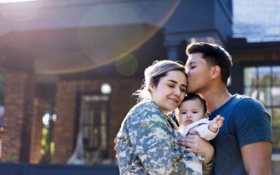 female Veterans with family in front of home