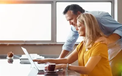 a couple at a computer looks at something