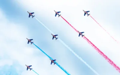 Jets flying in the sky with red. white, and blue smoke