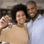 African American couple in new home holding keys