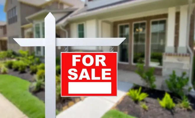 a home for sale with a for sale sign in front