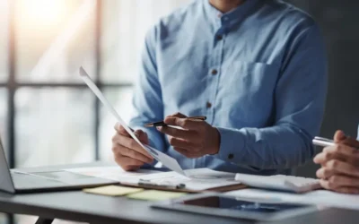 man in casual clothes reviewing documents at desk