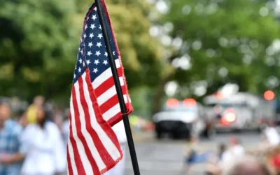 flag being raised in neighborhood for Veterans