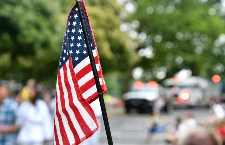 flag being raised in neighborhood for Veterans