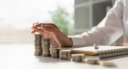 lady counting coins at desk