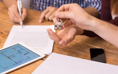 couple getting handing keys to new home by lender