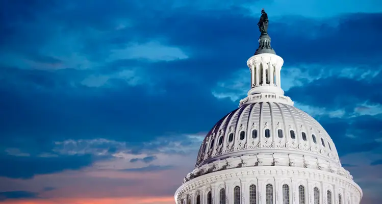 U.S. Capitol dome illuminated at twilight.