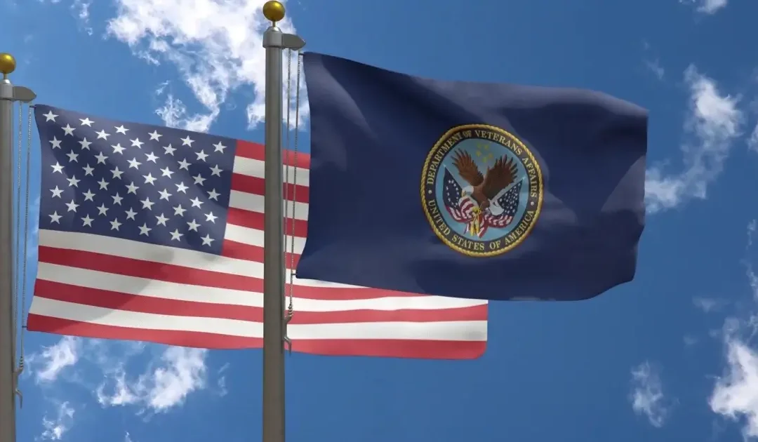 VA and American flag flying next to each other