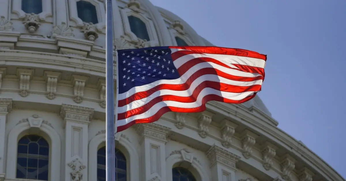 american flag flying in the wind on capital hill - government shutdown ending