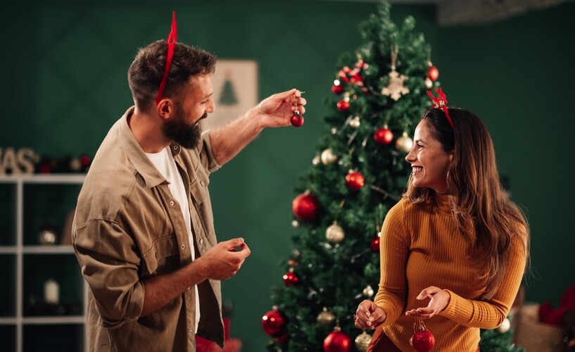 couple decorating christmas tree