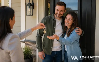 Couple holding house keys in front of new home