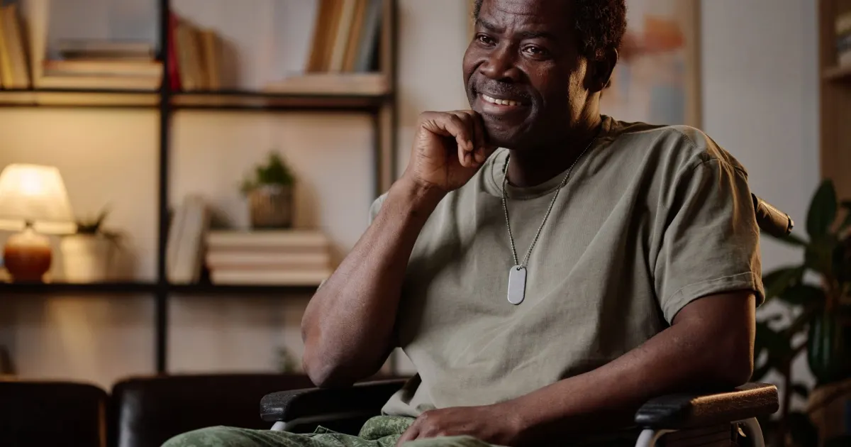 Disabled Veteran sitting at home and smiling during a conversation