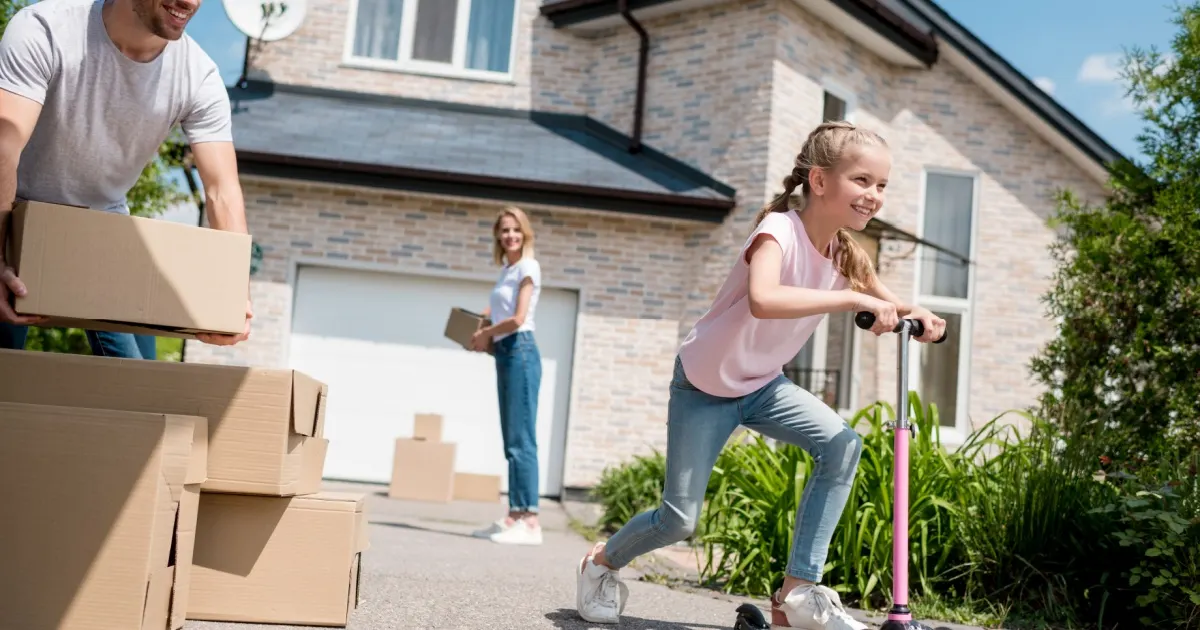Family moving into a new home with cardboard boxes